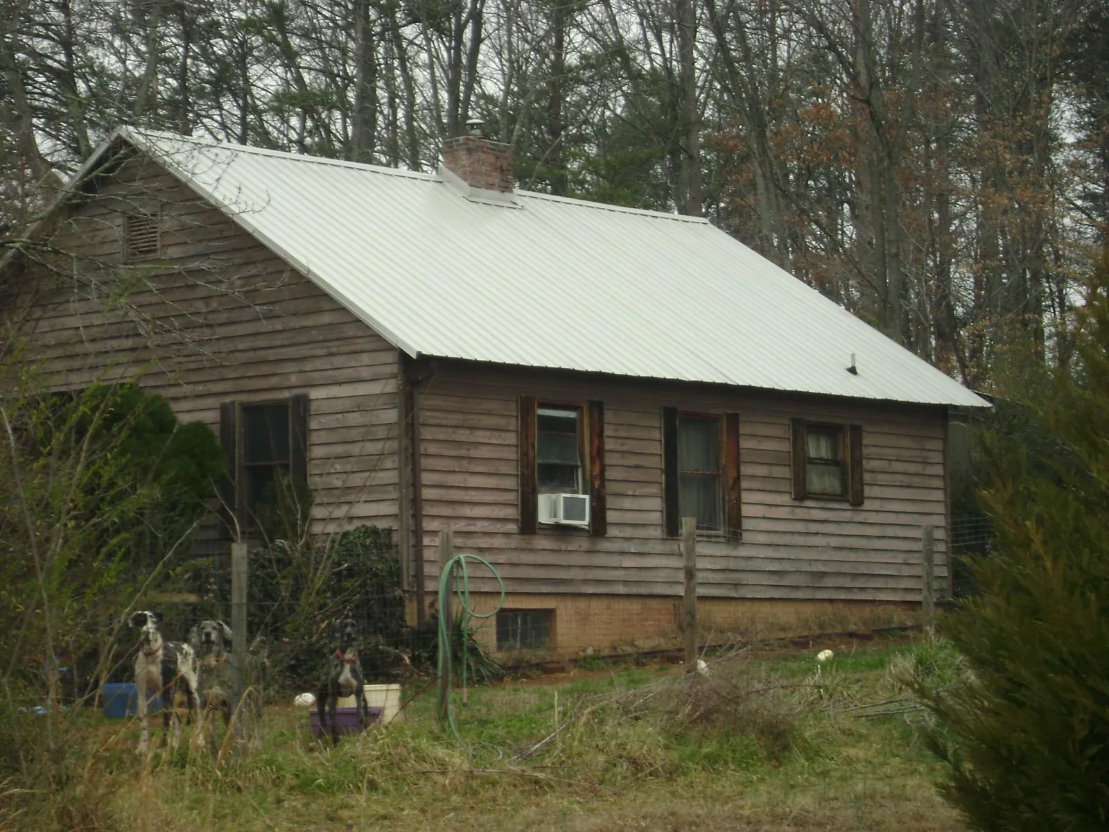 White metal roof on an old wood sided farmhouse, from a Metal Roof Installation job in Thompsons Station
